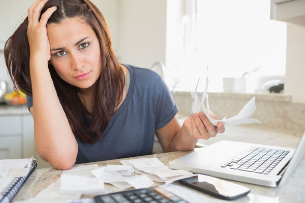 image of homeowner paying bills and air conditioning costs