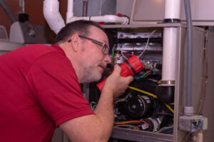 image of an hvac contractor performing annual furnace maintenance