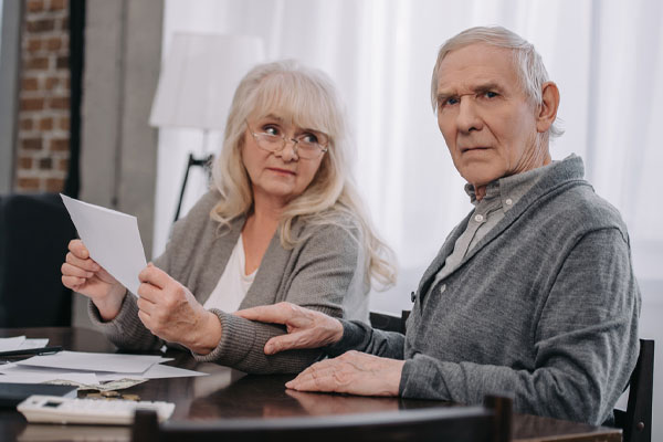 image of an elderly couple worreid about home heating bills