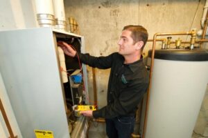 image of an hvac contractor performing annual furnace maintenance by columbus