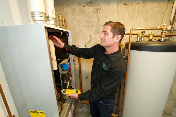 hvac contractor performing annual furnace maintenance by Columbus Energies