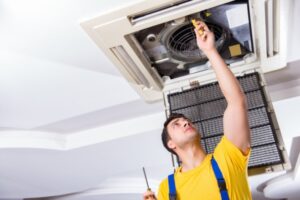 HVAC expert checking home central AC unit
