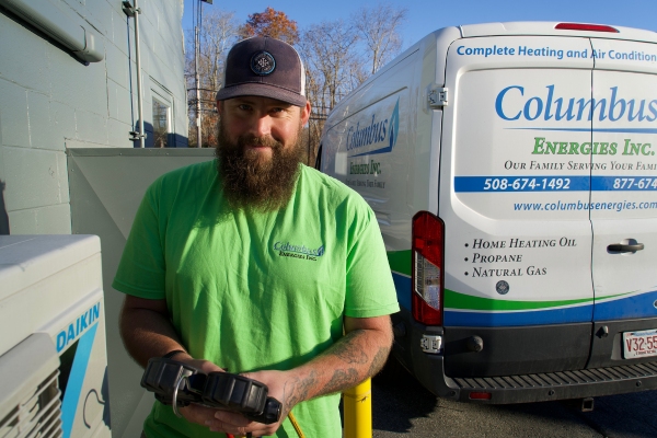 Columbus Energies HVAC technician with service van behind him