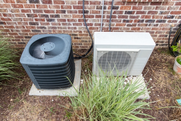 HVAC outdoor unit depicting needing clearing fan blades debris