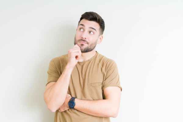 man looking at centralized air conditioner in the ceiling Identifying Overcharged AC Symptoms