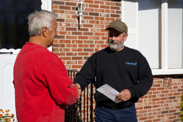 Columbus Energies professional staff shaking hands with client depicting professional assistance for backup generator maintenance