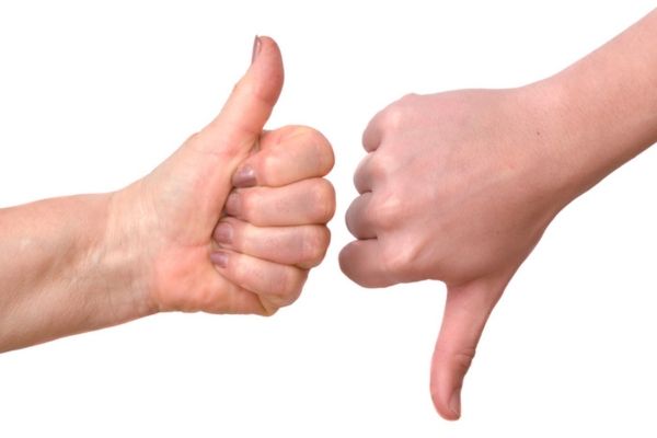 Hands showing thumb up and thumb down depicting advantage and disadvantage of furnace