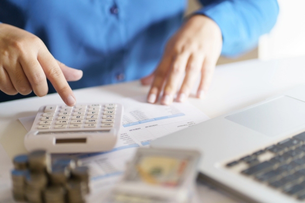 man with a calculator and documents assessing home's propane requirements