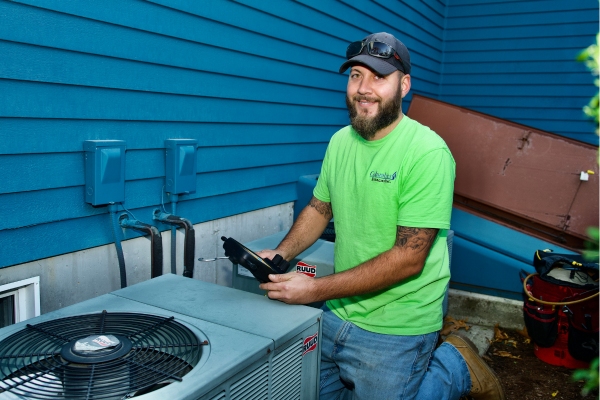 Columbus Energies HVAC technician performing air conditioner maintenance