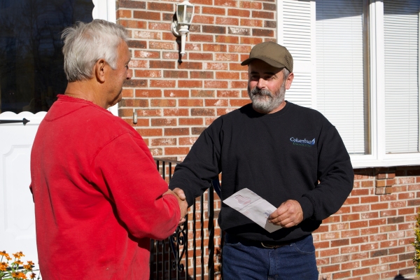 Columbus Energies HVAC representative shaking hands with a customer