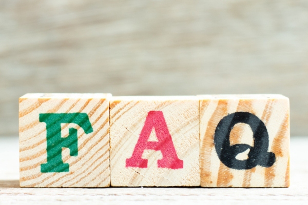 FAQ spelled using wooden letter blocks depicting questions about ducted vs ductless air conditioning systems