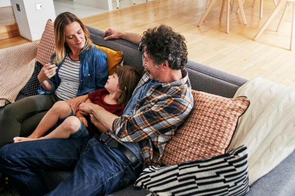 image of a family lounging at home with an energy efficient air conditioner