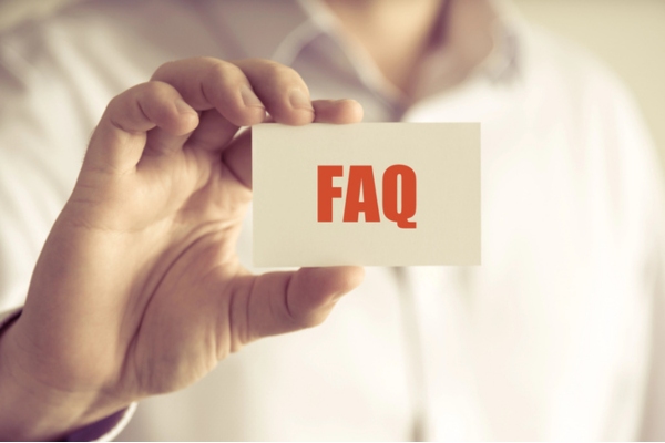 man holding a card that says FAQ depicting questions about Old Air Conditioners
