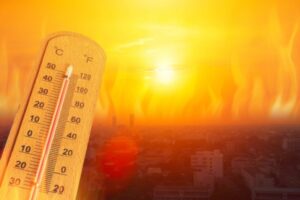 orange skyline and thermometer depicting intense summer heat