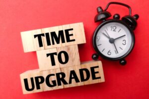 time to upgrade spelled using letter blocks beside an alarm clock depicting signs it's time for a generator upgrade