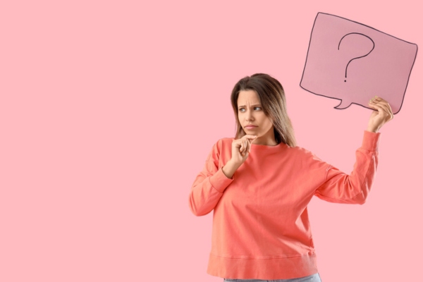 image of a wondering woman holding a speech bubble cutout with a question mark depicting Propane Myths FAQs