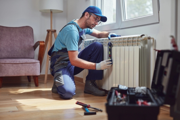 handyman fixing home heating radiator