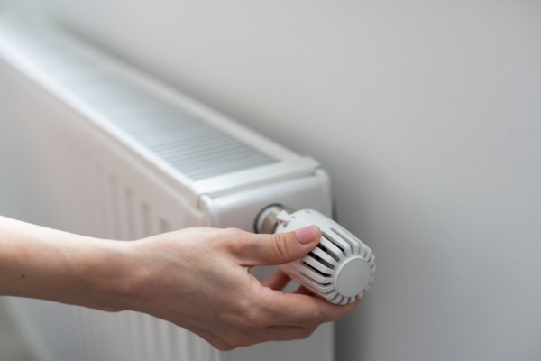 woman hands controlling home heating radiator