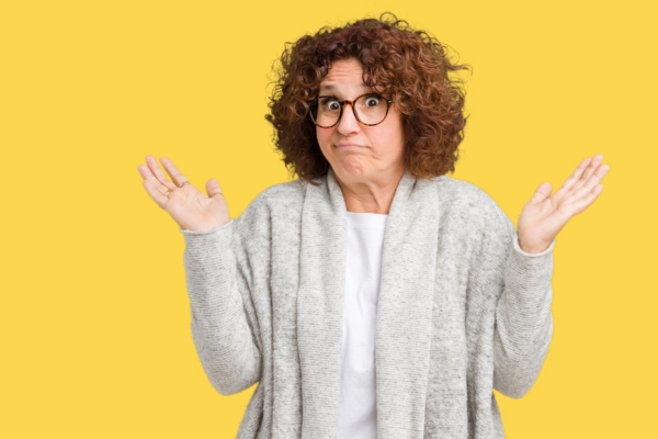 woman shrugging with her arms raised on the side depicting what size heating system does your home need