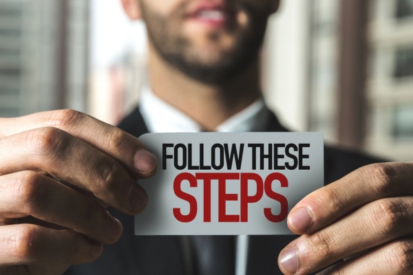 follow these steps written on a small paper shown by a man