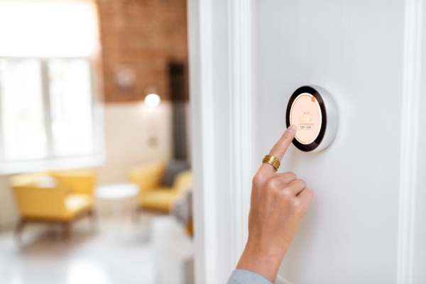 homeowner adjusting hvac thermostat