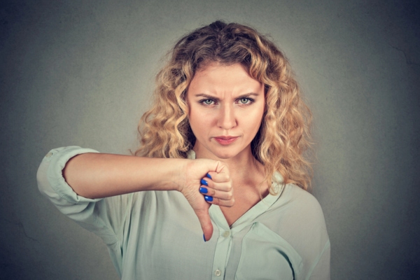 woman giving a thumbs down gesture debunking that Maintenance Can Wait Until a Failure Occurs