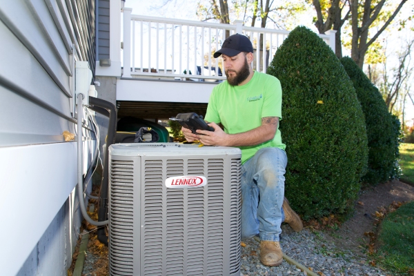 Columbus Energies HVAC technician tending to a central AC
