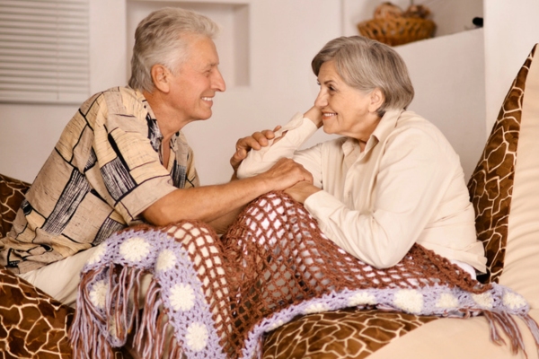 Happy beautiful elderly couple relaxing at home