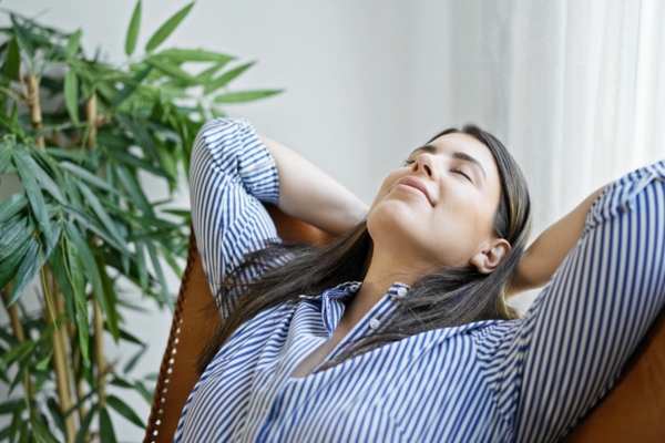 woman smiling with eyes closed depicting Enhanced Indoor Air Quality