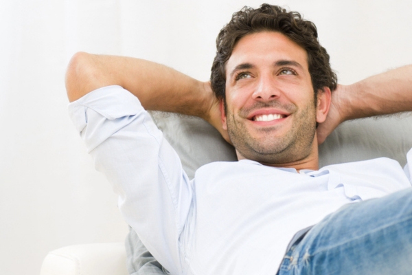 man lying on the couch feeling relaxed with new AC