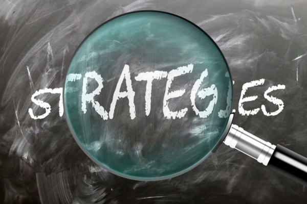 strategies written on a chalkboard highlighted by a magnifying glass depicting Summer Heating Oil Management