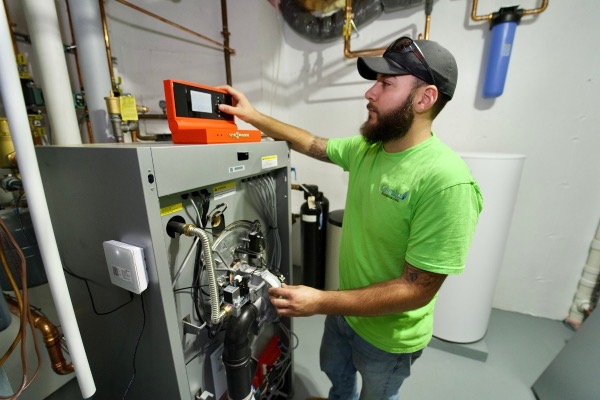 Fall River, MA technician performing furnace repair with diagnostic equipment