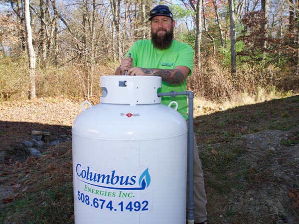 Middleboro, MA technician servicing a propane tank in a residential area